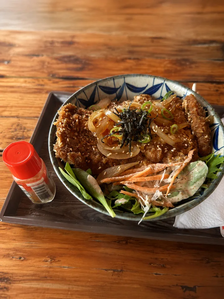 Donburi bowl with salad on a dining tray